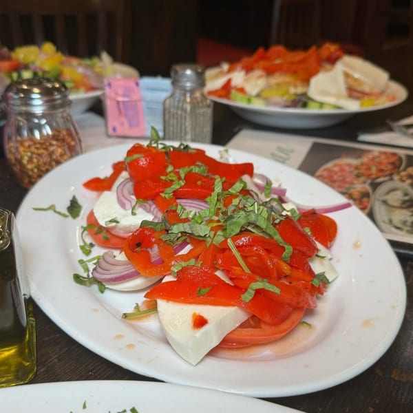 Caprese salad with red peppers, mozzarella, tomatoes, red onions, and basil at Roman Pizza.